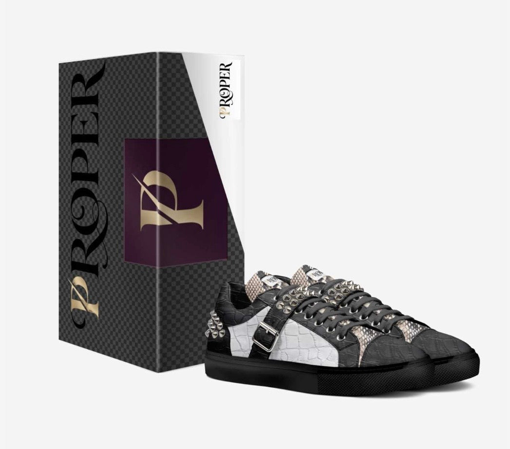 PROPER Signature Sneaker in BLACK CROC beside its PROPER box, with croc-textured panels, silver spikes and silver buckle