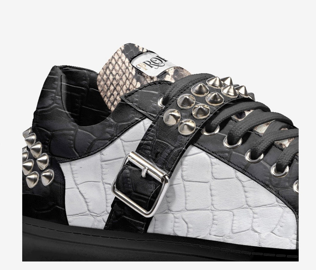 Close-up of the PROPER Signature Sneaker in BLACK CROC: silver spikes, buckle strap and croc-textured panels