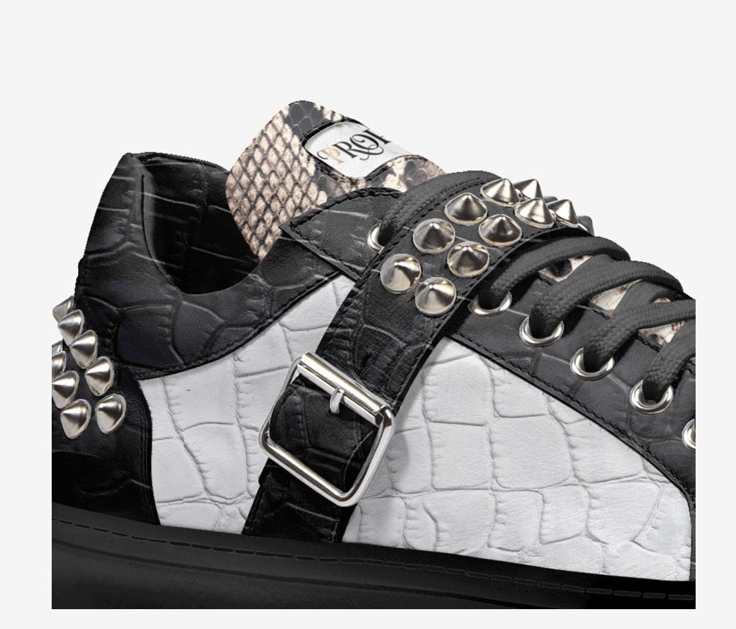 Close-up of the PROPER Signature Sneaker in BLACK CROC: silver spikes, buckle strap and croc-textured panels