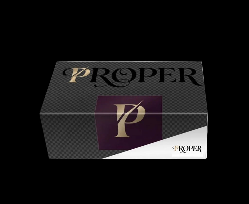 PROPER sneaker box in charcoal with the gold PROPER logo and plum P monogram