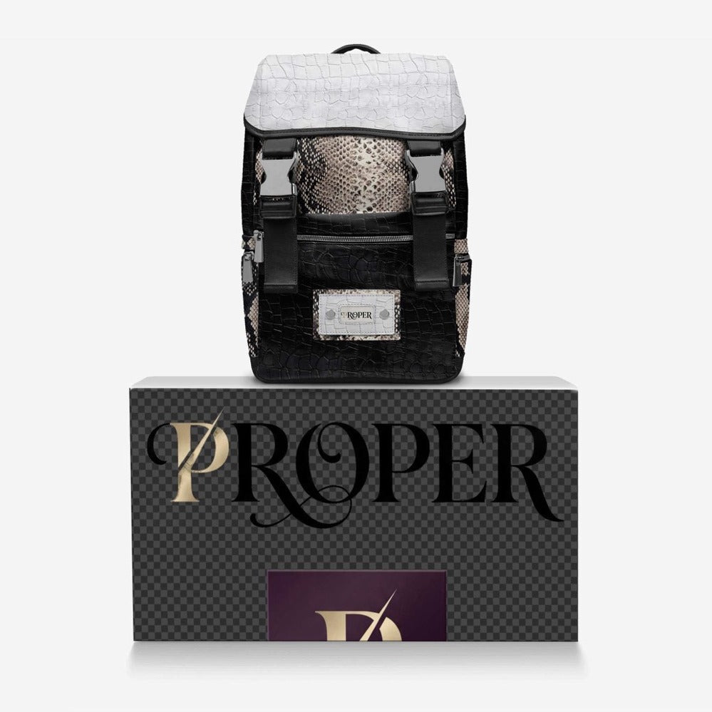 PROPER Signature Backpack in BLACK CROC resting on the PROPER box