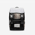 PROPER Signature Backpack in BLACK CROC, front view: black croc-textured body, white croc-textured flap, snake-textured panel and silver-tone buckles