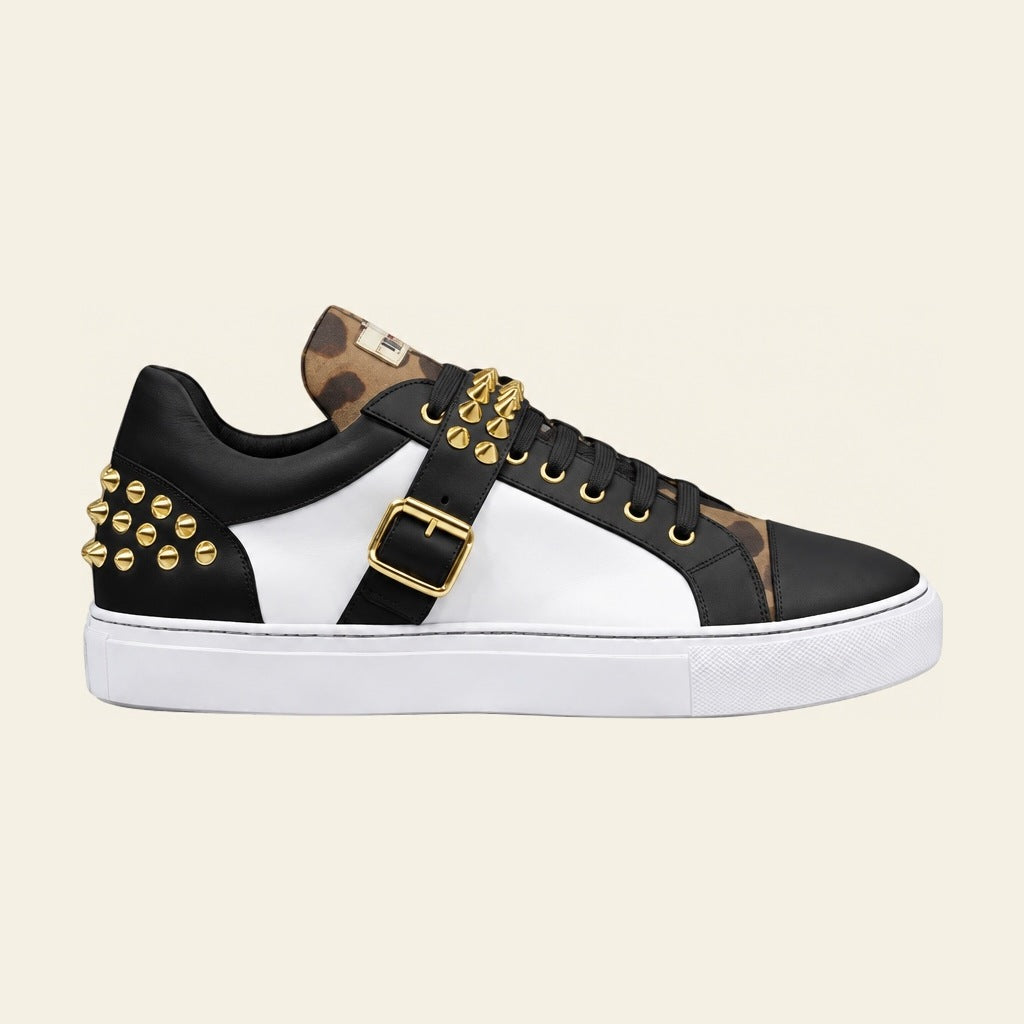 PROPER Signature Sneaker in NOIR: black and white panels, camo-print tongue, gold-tone spikes and buckle strap